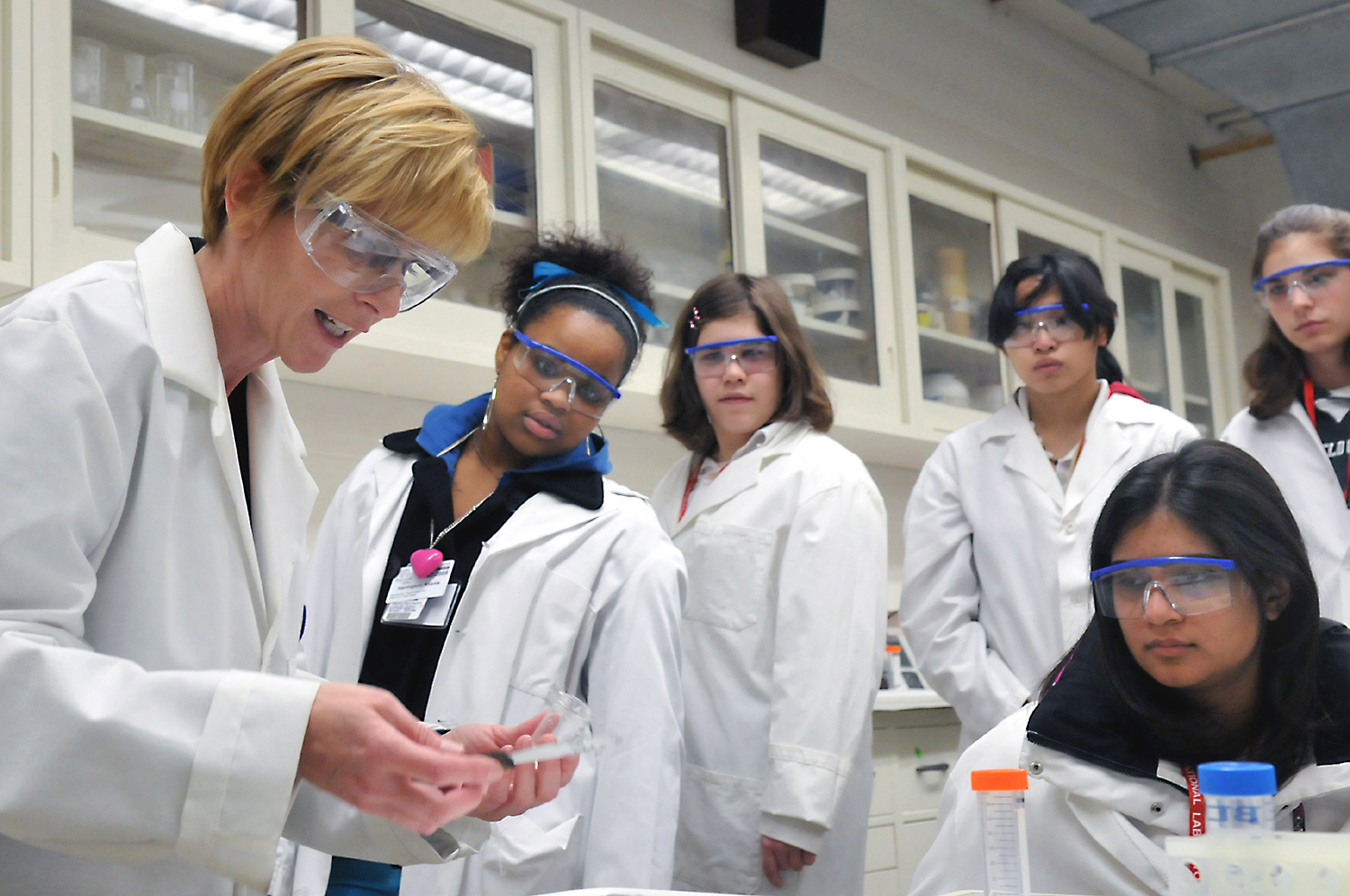 Students in a medical laboratory watch observe demonstration